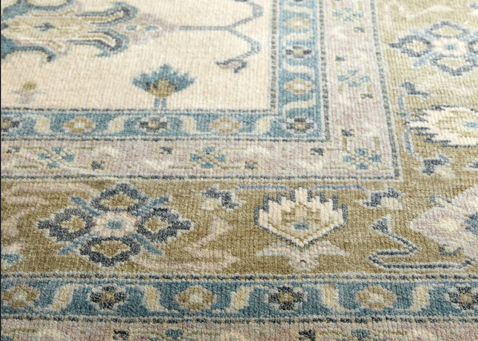 Close-up of a patterned rug with blue and beige colors